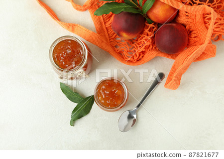 Peach jam and ingredients on white textured table Peach jam and ingredients on white textured table 87821677
