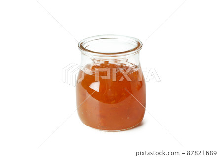 Jar of peach jam isolated on white background 87821689