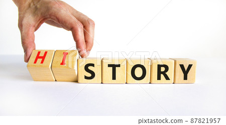 Story and history symbol. Historic turns a cube, changes the word story to history. Beautiful white table, white background. Business, historical and story or history concept. Copy space. 87821957