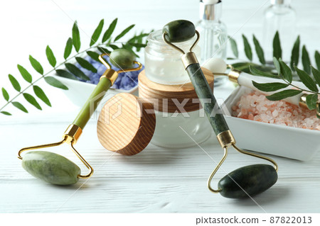 Skin care concept with face rollers on white wooden background Skin care concept with face rollers on white wooden background 87822013