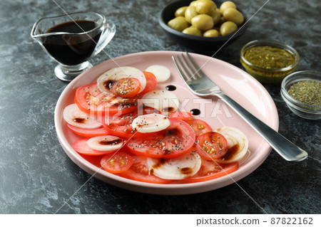 Concept of tasty food with tomato carpaccio on black smokey table 87822162