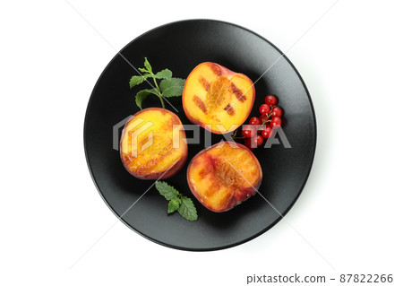 Plate with grilled peach isolated on white background Plate with grilled peach isolated on white background 87822266