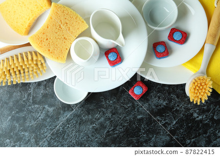 Concept of Dishwashing detergent accessories on black smokey table 87822415