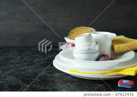 Concept of Dishwashing detergent accessories on black smokey table 87822416