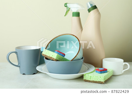 Concept of Dishwashing detergent accessories on white textured table Concept of Dishwashing detergent accessories on white textured table 87822429