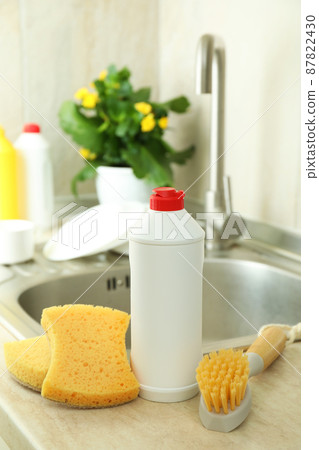 Concept of Dishwashing detergent accessories on kitchen background 87822430