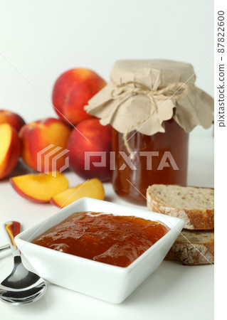 Peach jam and ingredients on white table Peach jam and ingredients on white table 87822600