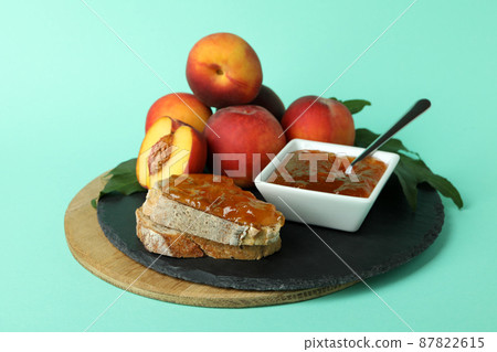 Sandwich with peach jam and ingredients on mint background Sandwich with peach jam and ingredients on mint background 87822615
