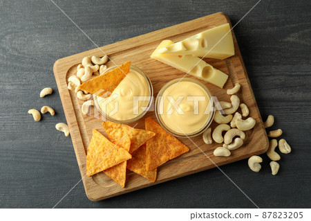 Concept of snack with cheese sauce on dark wooden table, top view Concept of snack with cheese sauce on dark wooden table, top view 87823205