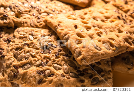 Oatmeal cookies with flax and sunflower seeds in blur. 87823391