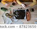 Happy children are planting plants at home. girl and boy sow seeds in natural gardening pots. 87823650