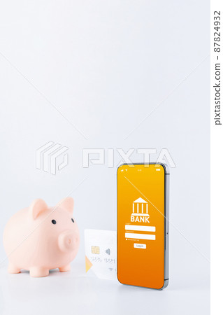 Mobile banking. Smartphone with internet online bank application. Piggy bank with debit card on white background. Save money business concept. Mobile banking. Smartphone with internet online bank application. Piggy bank with debit card on white background. Save money business concept. 87824932