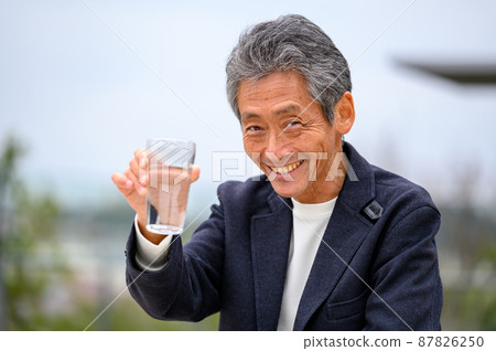 Senior male hydration, looking at the camera, casual 87826250