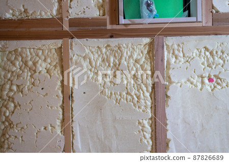 Walls of a new single-family home construction site with spray insulation 87826689