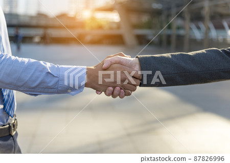 Team Business Partners shaking hands together to Greeting Start up small business in meeting room. Shakehand teamwork partners at modern office handshake together. Business mergers and acquisitions 87826996