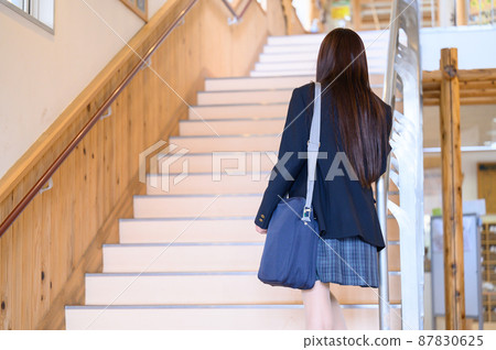 School girl who climbs the stairs School girl who climbs the stairs 87830625