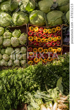 Large market stall full of organic vegetables 87831213
