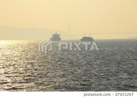 Cruise liner "Concerto" sailing in the golden strait of Akashi / Awaji Island in the distant view Cruise liner "Concerto" sailing in the golden strait of Akashi / Awaji Island in the distant view 87833267