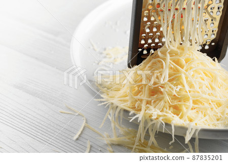 Grated cheese and grater. 87835201