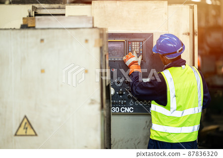 Professional engineer staff worker operate CNC machine working in heavy metal industry factory. Professional engineer staff worker operate CNC machine working in heavy metal industry factory. 87836320