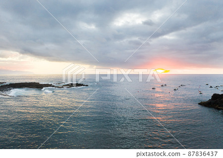 Top view at sunset of the ocean near the island of Tenerife.Canary Islands, Spain Top view at sunset of the ocean near the island of Tenerife.Canary Islands, Spain 87836437