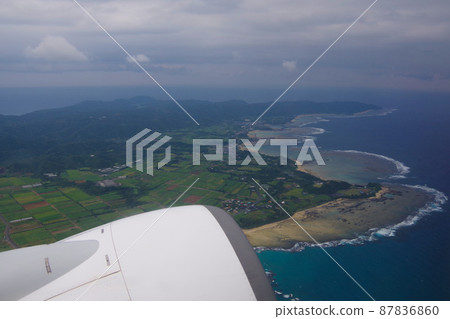 Amami Oshima, the view of the island after takeoff, the beautiful sea from the aircraft window 87836860