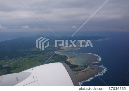 Amami Oshima, the view of the island after takeoff, the beautiful sea from the aircraft window 87836863