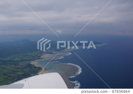 Amami Oshima, the view of the island after takeoff, the beautiful sea from the aircraft window 87836864