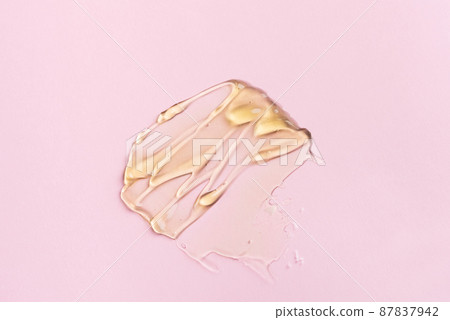 Liquid gel cosmetic product with bubbles on pink background 87837942