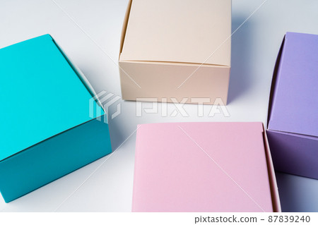 Pile of colorful cardboard boxes on white background Pile of colorful cardboard boxes on white background 87839240