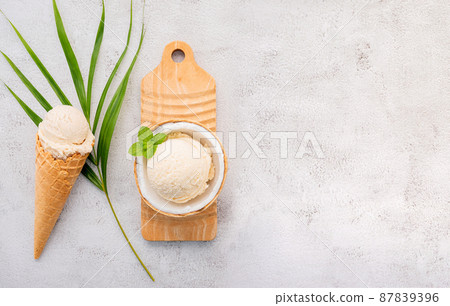 Coconut ice cream flavours in half of coconut setup on white stone background. Summer and Sweet menu concept. 87839396