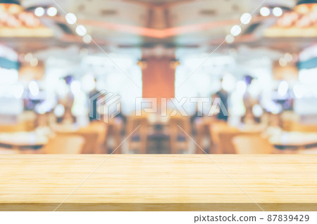 Empty wood table top with cafe restaurant interior blurred background Empty wood table top with cafe restaurant interior blurred background 87839429