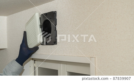 Image of a worker who installs, repairs, and cleans a ventilation fan for a bath Image of a worker who installs, repairs, and cleans a ventilation fan for a bath 87839907