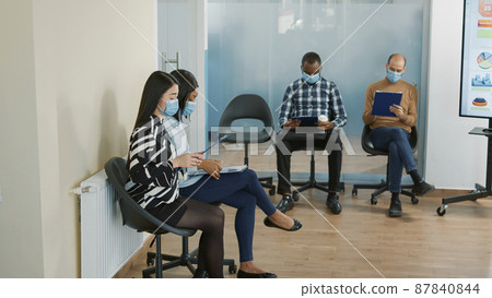 Office worker inviting candidate to enter job interview meeting, preparing cv resume for selection. Woman starting employment appointment for career opportunity during pandemic. 87840844