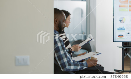 HR worker inviting female applicant to attend job interview in office, leaving waiting lobby. Woman starting selection meeting appointment with executive manager, talking about employment. HR worker inviting female applicant to attend job interview in office, leaving waiting lobby. Woman starting selection meeting appointment with executive manager, talking about employment. 87840968