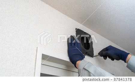 Image of a worker who installs, repairs, and cleans a ventilation fan for a bath 87841378