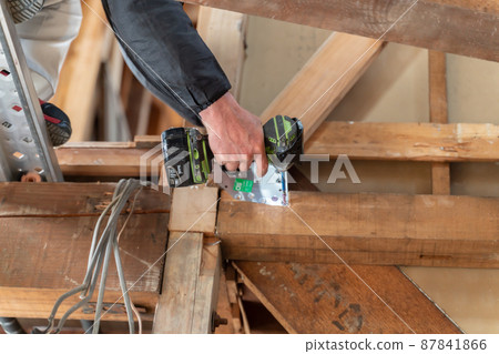 Home remodeling site, working carpenter, screwing Home remodeling site, working carpenter, screwing 87841866