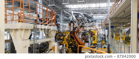 Panoramic photo of automobile production line. Welding car body. Modern car assembly plant. Auto 87842000