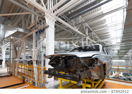 Car bodies are on assembly line. Factory for production of cars. Modern automotive industry. A car 87842012