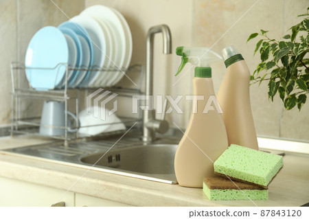 Concept of Dishwashing detergent accessories on kitchen background Concept of Dishwashing detergent accessories on kitchen background 87843120
