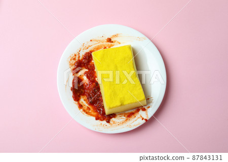 Concept of dirty dishes on pink background 87843131