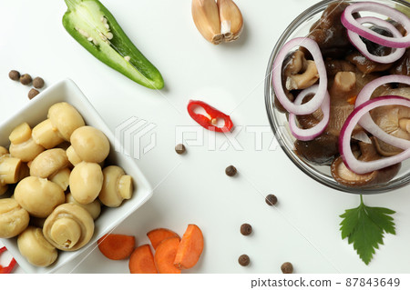 Bowls of marinated mushrooms on white background Bowls of marinated mushrooms on white background 87843649