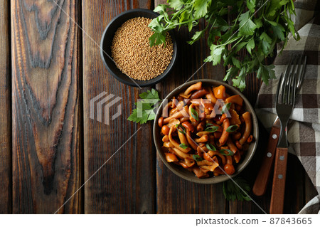 Concept of tasty food with marinated mushrooms on wooden table 87843665