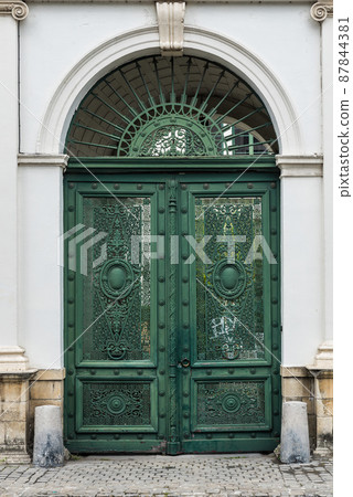 Tournai Doornik, Walloon Region - Belgium - Detail of a worn metal entrance door Tournai Doornik, Walloon Region - Belgium - Detail of a worn metal entrance door 87844381