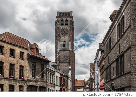 Tournai Doornik, Walloon Region  Belgium -  Facades of residential and commercial buildings in old town with the tower of the Saint Brice church 87844383