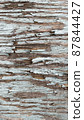 Close-up background with cracked blue paint texture on gray wood 87844427