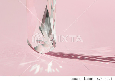 Crystal prism with light diffraction of spectrum colours and reflection with trendy light and hard shadows on pink background. Light spectrum reflected through glass prism. Crystal prism with light diffraction of spectrum colours and reflection with trendy light and hard shadows on pink background. Light spectrum reflected through glass prism. 87844491