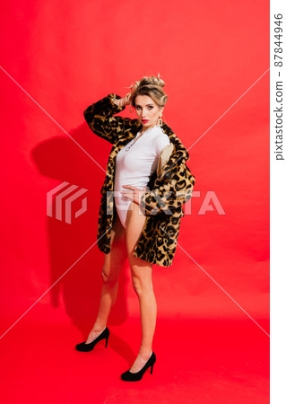 Young woman in white bodysuit posing on studio background. Female fashion, beauty and body concept Young woman in white bodysuit posing on studio background. Female fashion, beauty and body concept 87844946