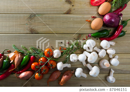 Mushrooms, vegetables, herbs on wooden surface Mushrooms, vegetables, herbs on wooden surface 87846151