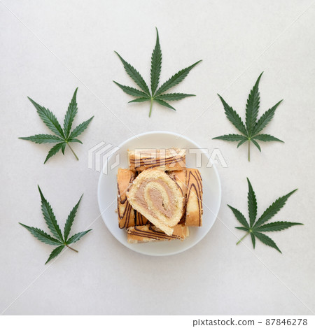 Sweet roll with marijuana oil on white plate. Cannabis kitchen 87846278